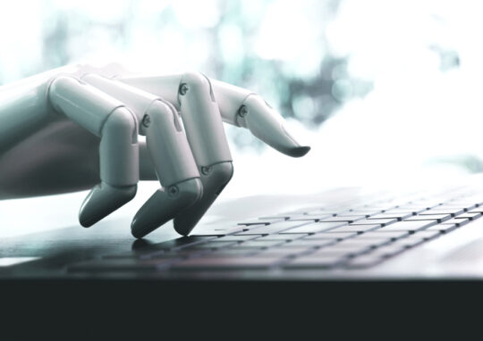 robot's hand types on keyboard