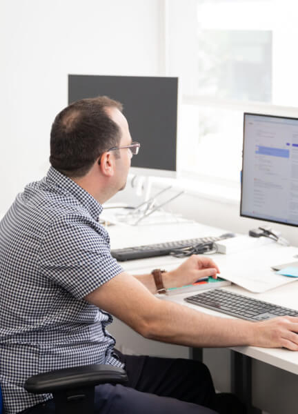 Enhance Media employee at his desk